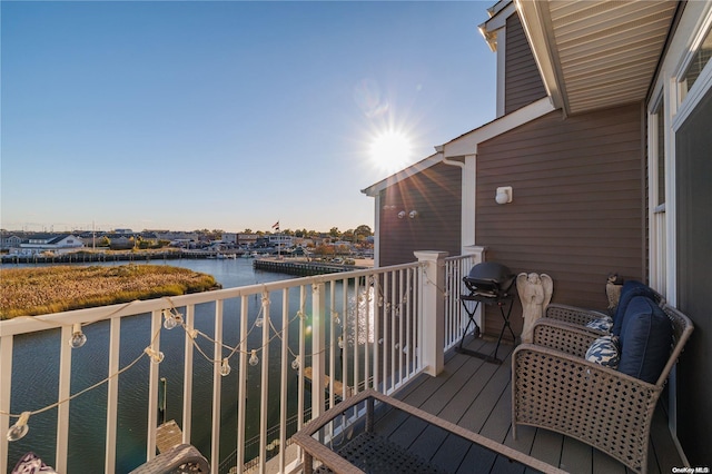 balcony featuring a water view and grilling area