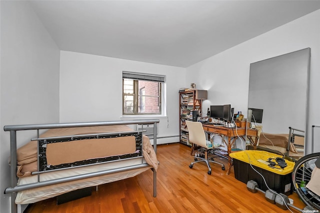 office with light wood-type flooring and a baseboard heating unit