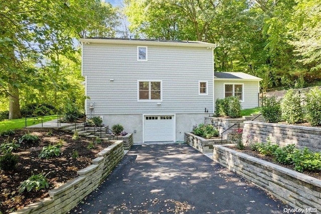 back of property with a garage