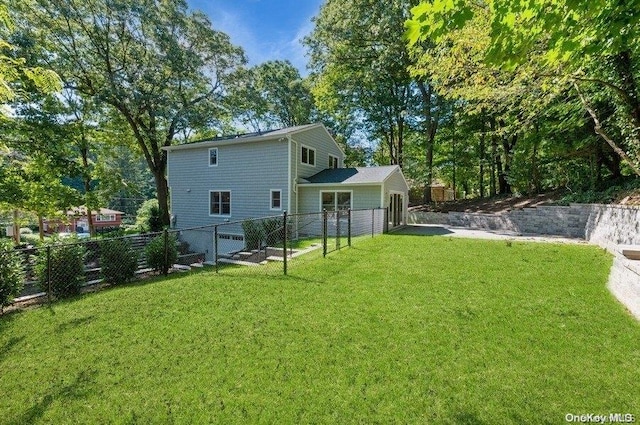 rear view of house with a lawn