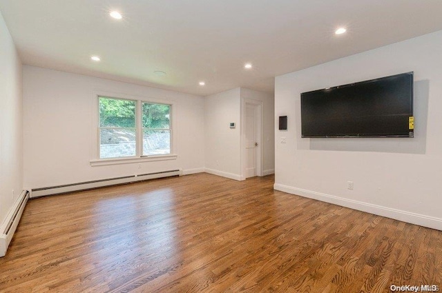 unfurnished living room with light hardwood / wood-style floors and a baseboard radiator