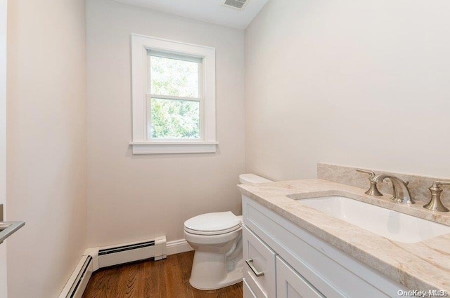 bathroom featuring toilet, vanity, a baseboard radiator, and hardwood / wood-style flooring