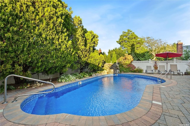 view of swimming pool with a patio area