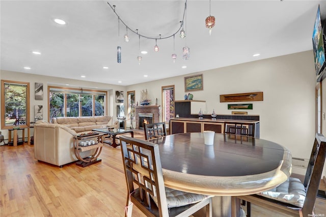 dining area with a fireplace and light hardwood / wood-style floors