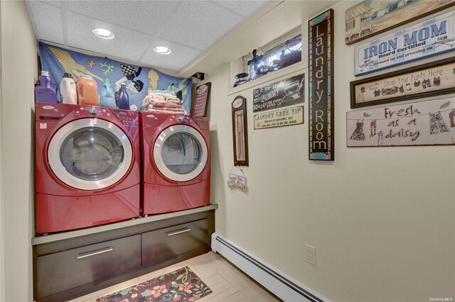 laundry area featuring baseboard heating and separate washer and dryer