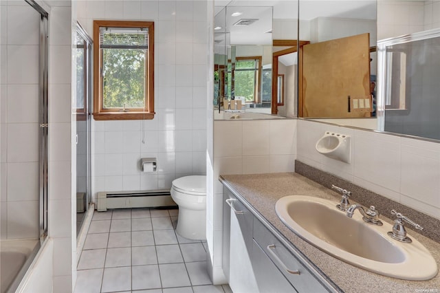 full bathroom with tile patterned floors, vanity, a baseboard heating unit, tile walls, and toilet