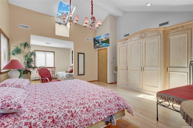 bedroom featuring beam ceiling, a skylight, high vaulted ceiling, a notable chandelier, and light wood-type flooring