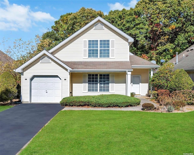 view of front property featuring a garage and a front lawn