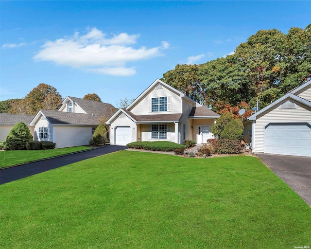 view of front of property featuring a garage and a front lawn