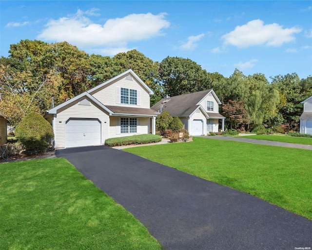 view of front of house featuring a garage and a front lawn