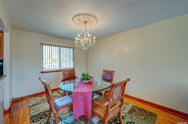 dining room with a chandelier and hardwood / wood-style flooring