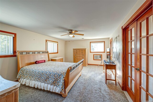 carpeted bedroom with ceiling fan and multiple windows