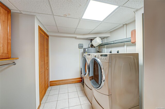 laundry area with washing machine and clothes dryer and light tile patterned flooring