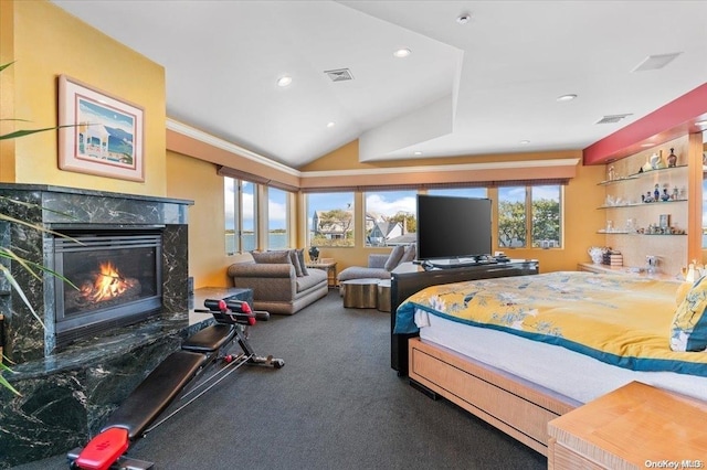 bedroom with a fireplace, carpet, and vaulted ceiling