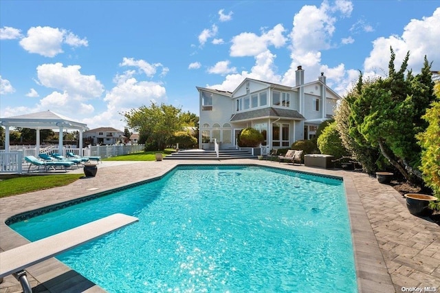 view of pool with a gazebo, a diving board, and a patio area