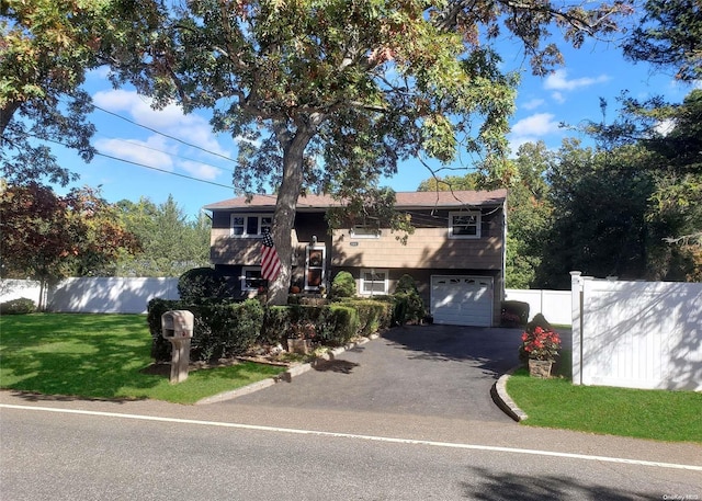 view of front facade featuring a garage and a front lawn