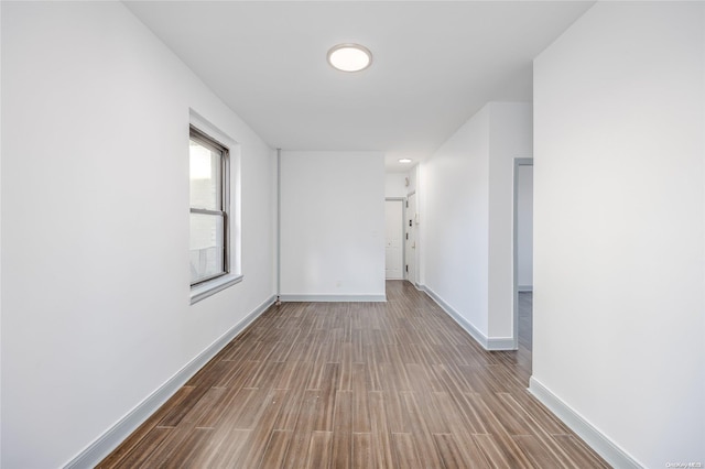 hallway with hardwood / wood-style flooring