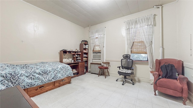 bedroom with radiator and crown molding