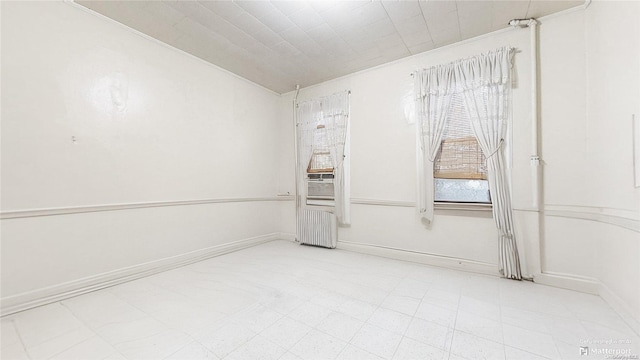 empty room featuring ornamental molding