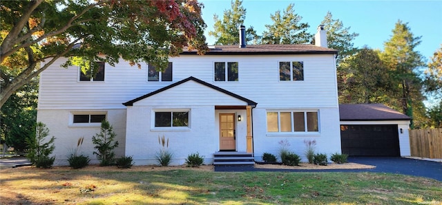 view of front of home with a front yard and a garage