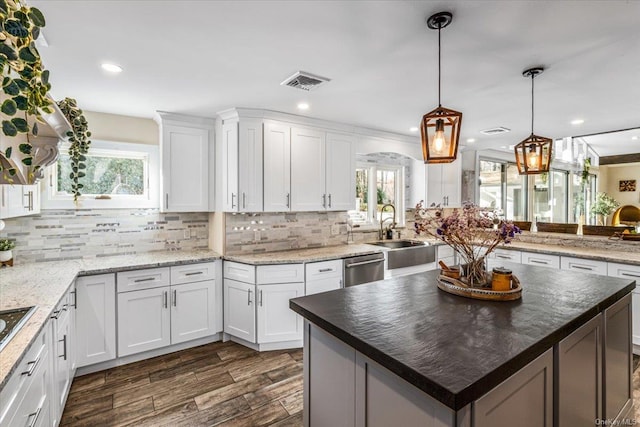 339 Ridge Ln, Mill Neck, NY 11765 - kitchen featuring decorative backsplash, white cabinets, stainless steel dishwasher, dark wood finished floors, and recessed lighting
