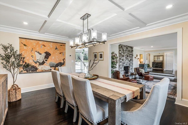 339 Ridge Ln, Mill Neck, NY 11765 - dining area with coffered ceiling, a chandelier, dark wood finished floors, crown molding, and a fireplace