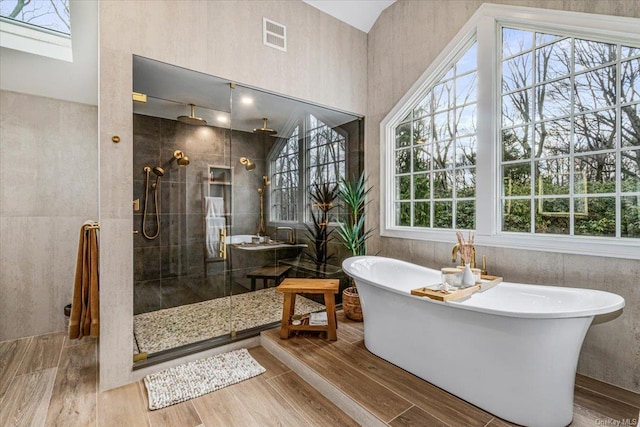 339 Ridge Ln, Mill Neck, NY 11765 - full bath featuring a tile shower, a soaking tub, and wood finished floors