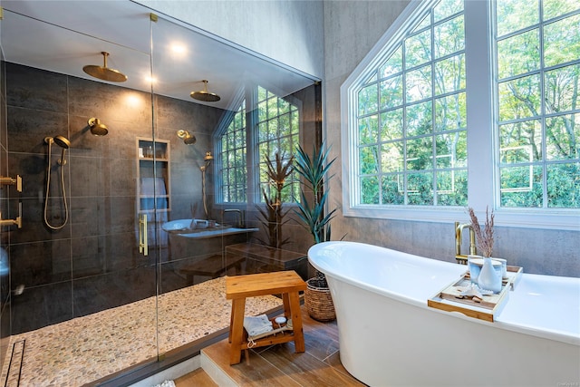 bathroom with hardwood / wood-style floors and independent shower and bath