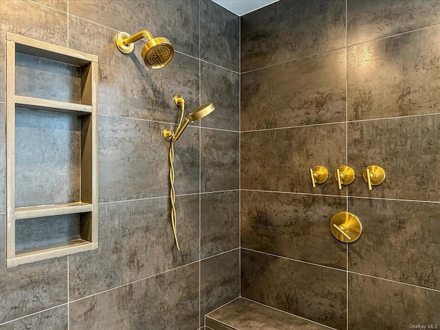 interior details with a tile shower