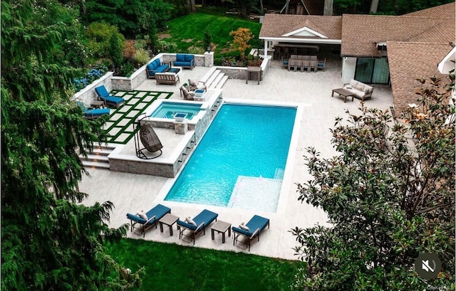 view of swimming pool with an in ground hot tub, a bar, a patio, and an outdoor hangout area