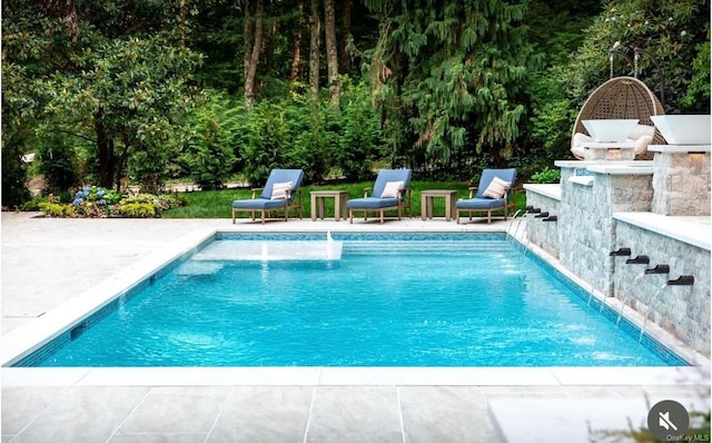 view of swimming pool with pool water feature