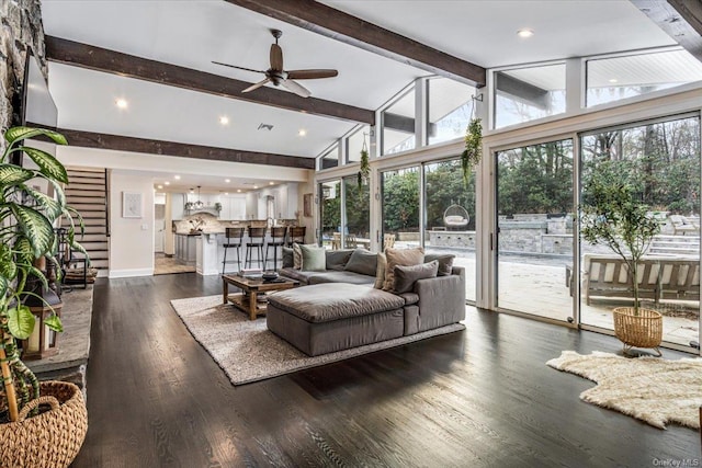 living room with beamed ceiling, dark hardwood / wood-style floors, ceiling fan, and high vaulted ceiling