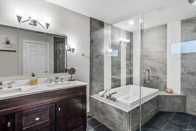 bathroom featuring tile patterned flooring, vanity, and shower with separate bathtub