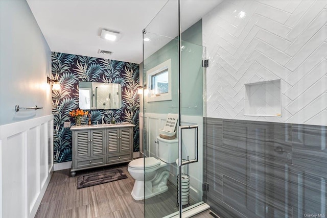 339 Ridge Ln, Mill Neck, NY 11765 - full bathroom featuring wallpapered walls, an accent wall, vanity, a shower with door, and wainscoting