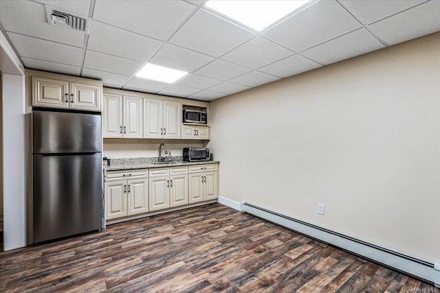 339 Ridge Ln, Mill Neck, NY 11765 - kitchen with appliances with stainless steel finishes, baseboard heating, dark wood finished floors, a drop ceiling, and light stone countertops