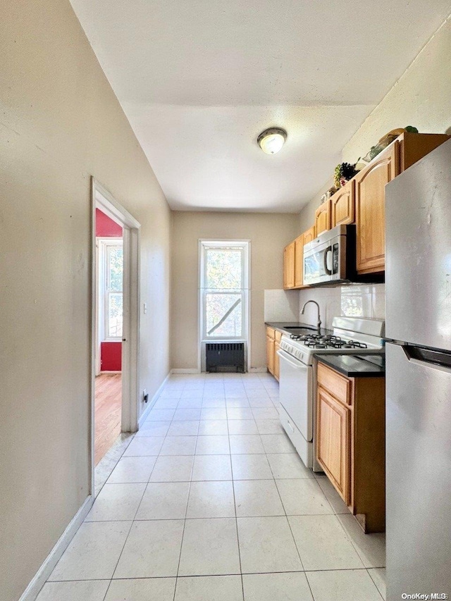 kitchen with stainless steel appliances and light tile patterned flooring