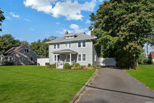 view of front of house featuring covered porch and a front yard