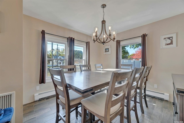 dining area with plenty of natural light, wood-type flooring, and a baseboard heating unit