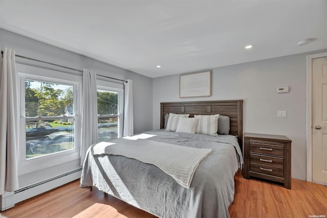 bedroom featuring light hardwood / wood-style flooring and a baseboard radiator