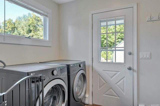 clothes washing area with washing machine and clothes dryer and a healthy amount of sunlight