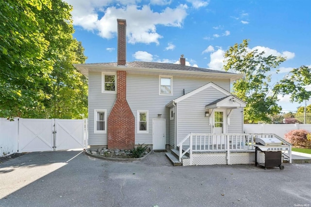 rear view of house featuring a deck