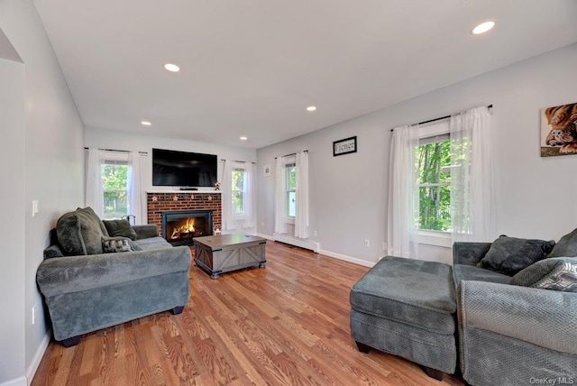 18955 Main Rd, Mattituck, NY 11952 - living room with healthy amount of natural light, light wood finished floors, a brick fireplace, and recessed lighting