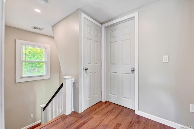 18955 Main Rd, Mattituck, NY 11952 - hallway with an upstairs landing, light wood-type flooring, and baseboards