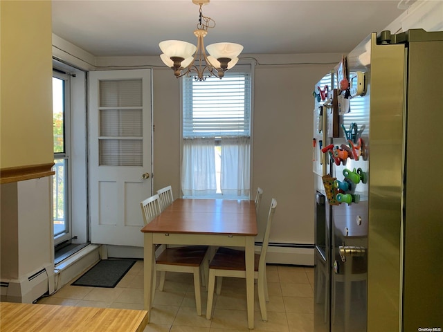 tiled dining space featuring a notable chandelier