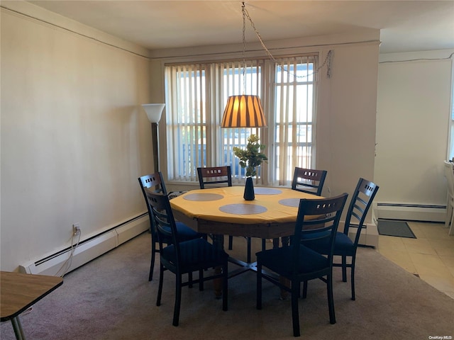 tiled dining space featuring a baseboard heating unit