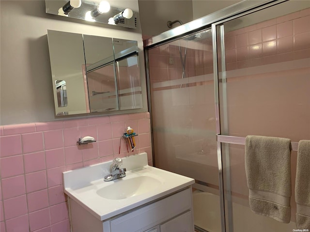 bathroom with vanity and tile walls