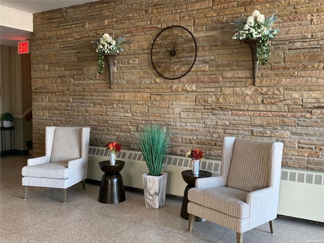 sitting room with brick wall