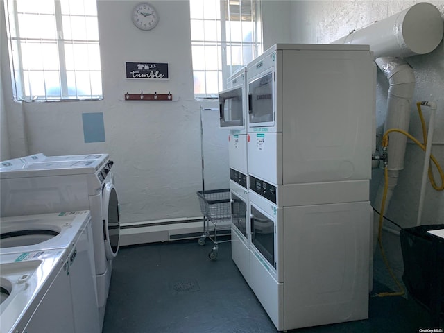 laundry area with plenty of natural light, stacked washing maching and dryer, and washing machine and clothes dryer