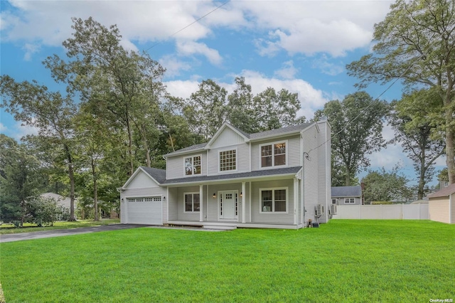 view of front of property with a garage, covered porch, and a front lawn