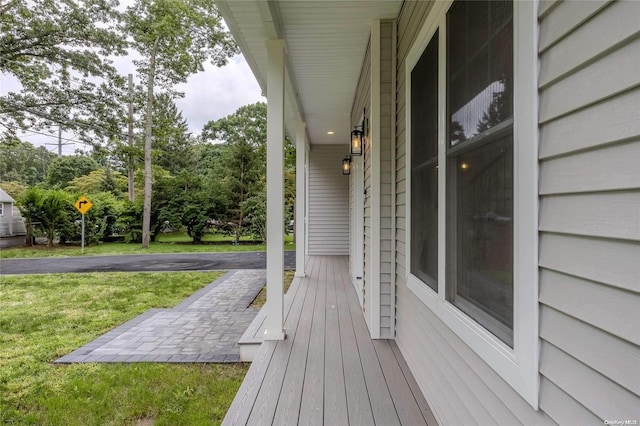 wooden terrace with a lawn